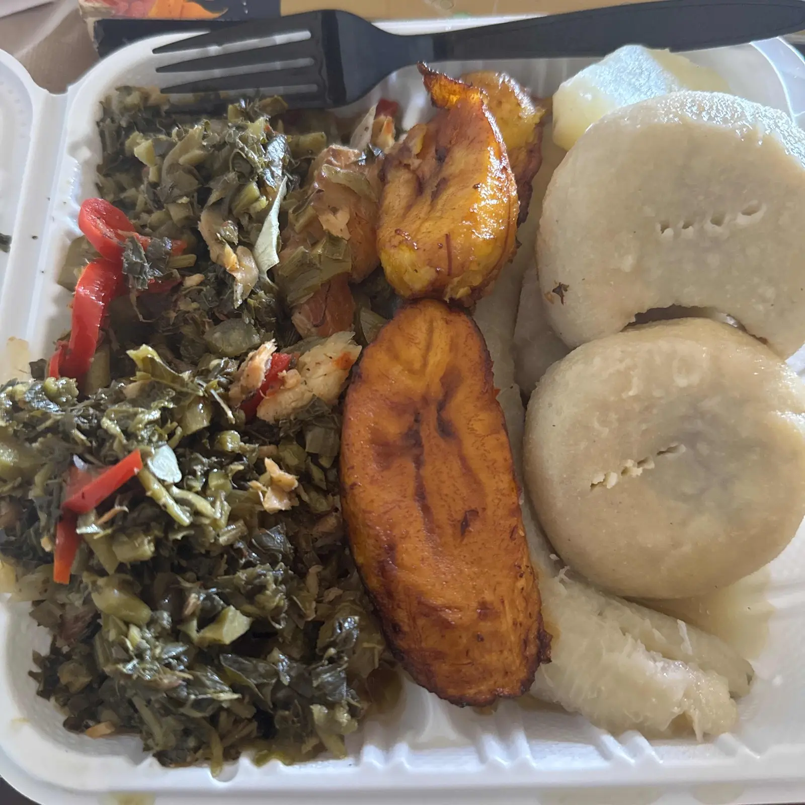 Callaloo with boiled dumplings, plantains and yam