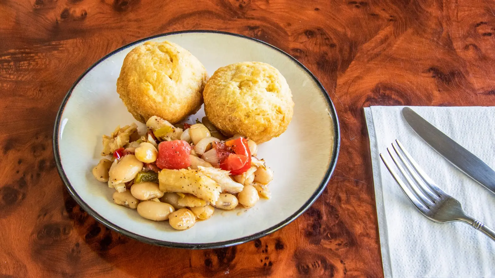 Salt fish with fried dumplings, peppers, onions and plantains
